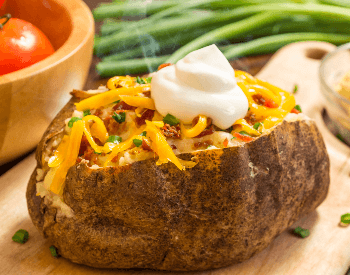 A picture of a baked potato with toppings