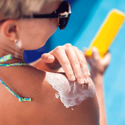 A picture of a woman applying sunscreen