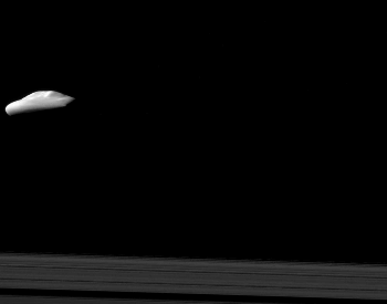 A photo of Atlas near one of Saturn's rings