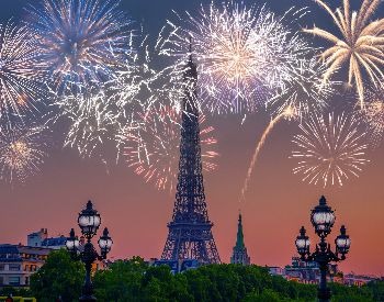A picture of the Eiffel Tower with fireworks going off around it