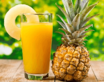 A picture of a pineapple and pineapple juice