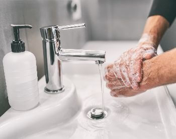 A picture of someone washing their hands with soap