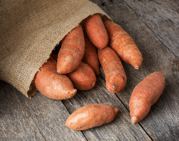 A picture of a bag full of sweet potatoes