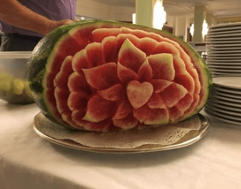 A picture of a watermelon with a beautiful carving