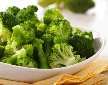 A picture of a bowl that contains steamed broccoli