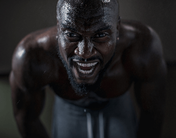 A picture of a man sweating from working out