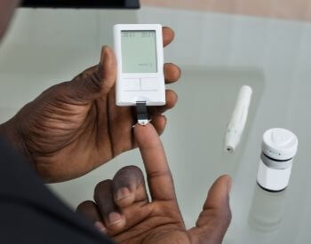 A picture of a man with diabetes testing his blood sugar level
