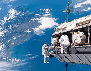 A picture of astronauts doing an EVA outside the ISS Space Station