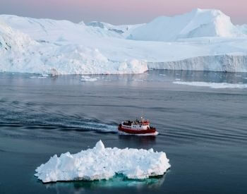 A picture of a boat sailing through the Arctic Ocean