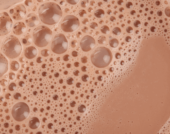 A close-up picture of chocolate milk in a glass