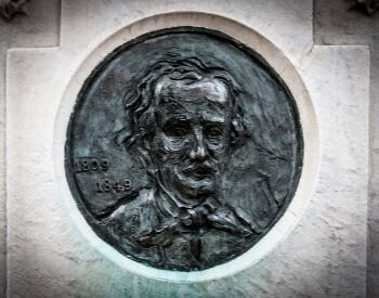 A picture of the self-portrait cast of Edgar Allan Poe on his tombstone