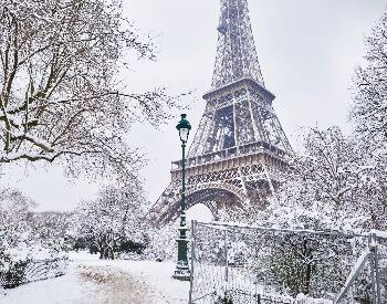 A picture of the Eiffel Tower with snow on it during the winter
