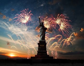 A picture of fireworks around the Statue of Liberty