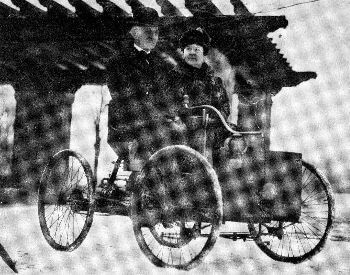 A picture of Henry Ford and his wife on a Quadricyle