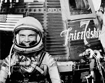 A photo of John Glenn in front of the Friendship 7 Mercury spacecraft