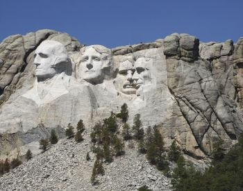 A picture of Mount Rushmore from the highway that passes it