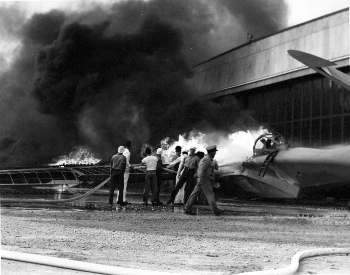 A picture of a PBY patrol bomber on fire after the Pearl Harbor attack