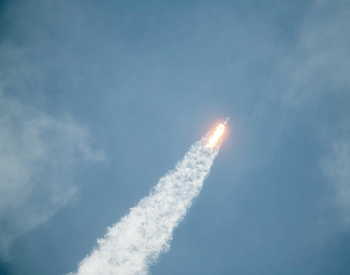 A picture of a SpaceX commerical rocket in the air
