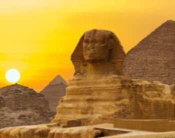 A picture of the Sphinx statue during a sunset