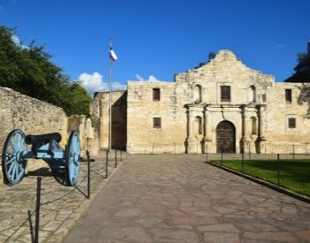 A picture of the Alamo and a cannon