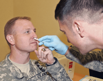 A vaccine being administered via nasal inhalation