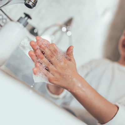 A picture of someone washing their hands with soap