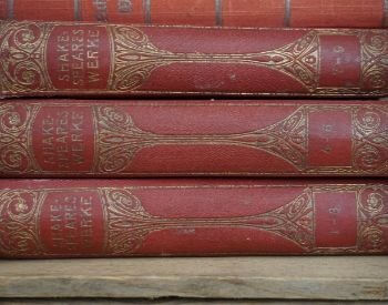 A picture of old William Shakespeare books on a shelf