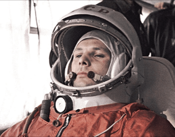 A photo of Yuri Gagarin on a bus in his cosmonaut space suit